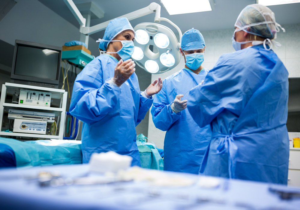 Surgeons interacting with each other in operation room at hospital