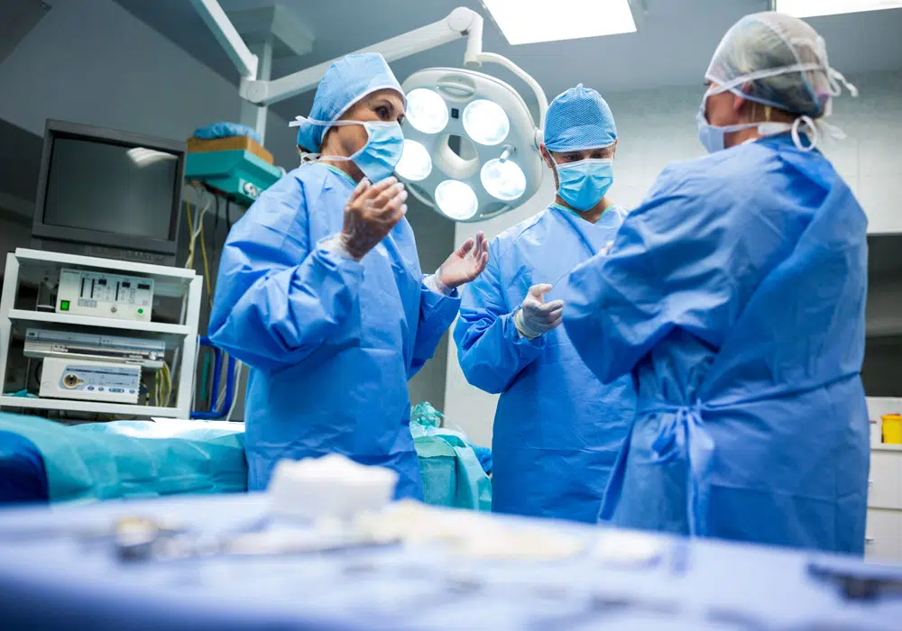 Surgeons interacting with each other in operation room at hospital